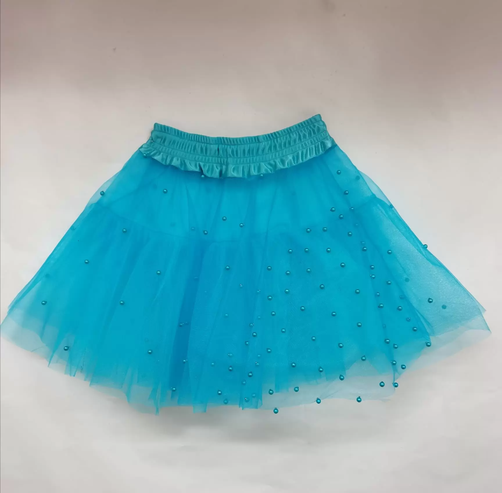 Faldilla perles turquesa
